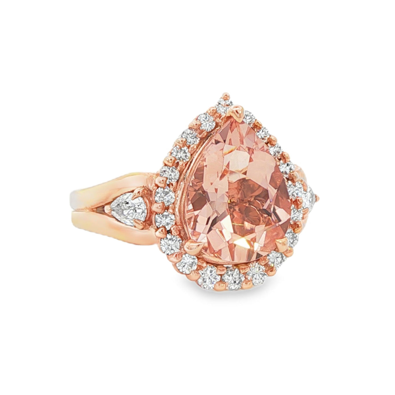 14K Rose gold ring set with a pear shape morganite surrounded with a diamond halo. Item J33283 - ABC Jewelry Co.