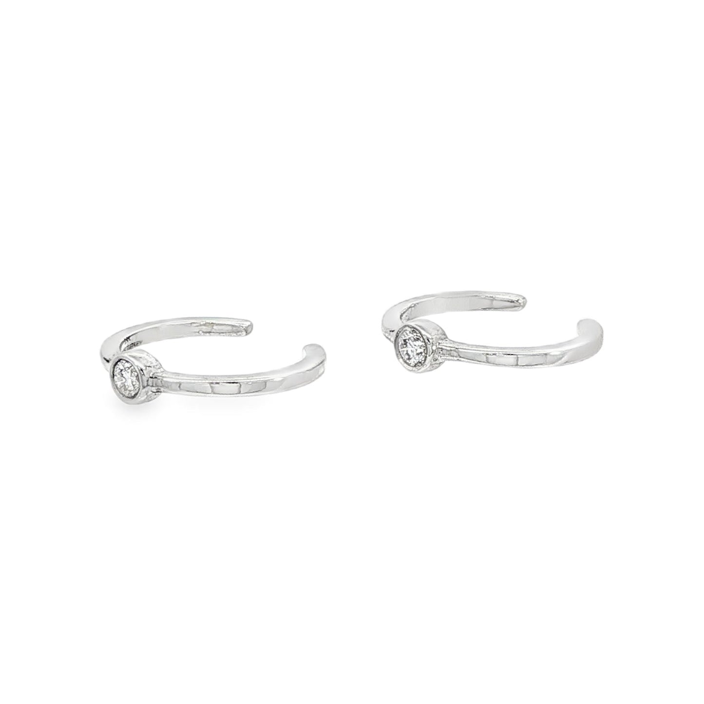 14K White gold ear cuffs, each with 1 bezel set round brilliant diamond. Item J34614 - ABC Jewelry Co.