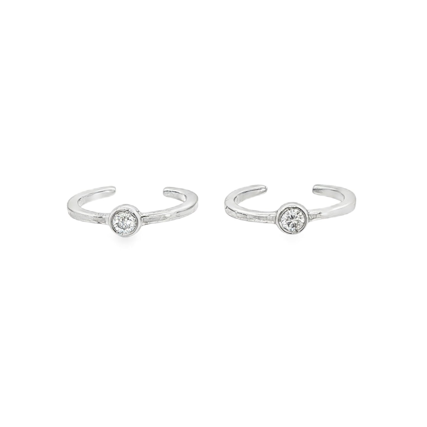 14K White gold ear cuffs, each with 1 bezel set round brilliant diamond. Item J34614 - ABC Jewelry Co.