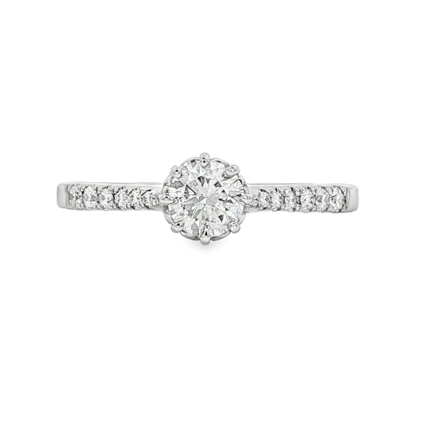 18K White gold ring featuring a round brilliant diamond center stone and accented with diamonds down the shank. Item J34776 - ABC Jewelry Co.