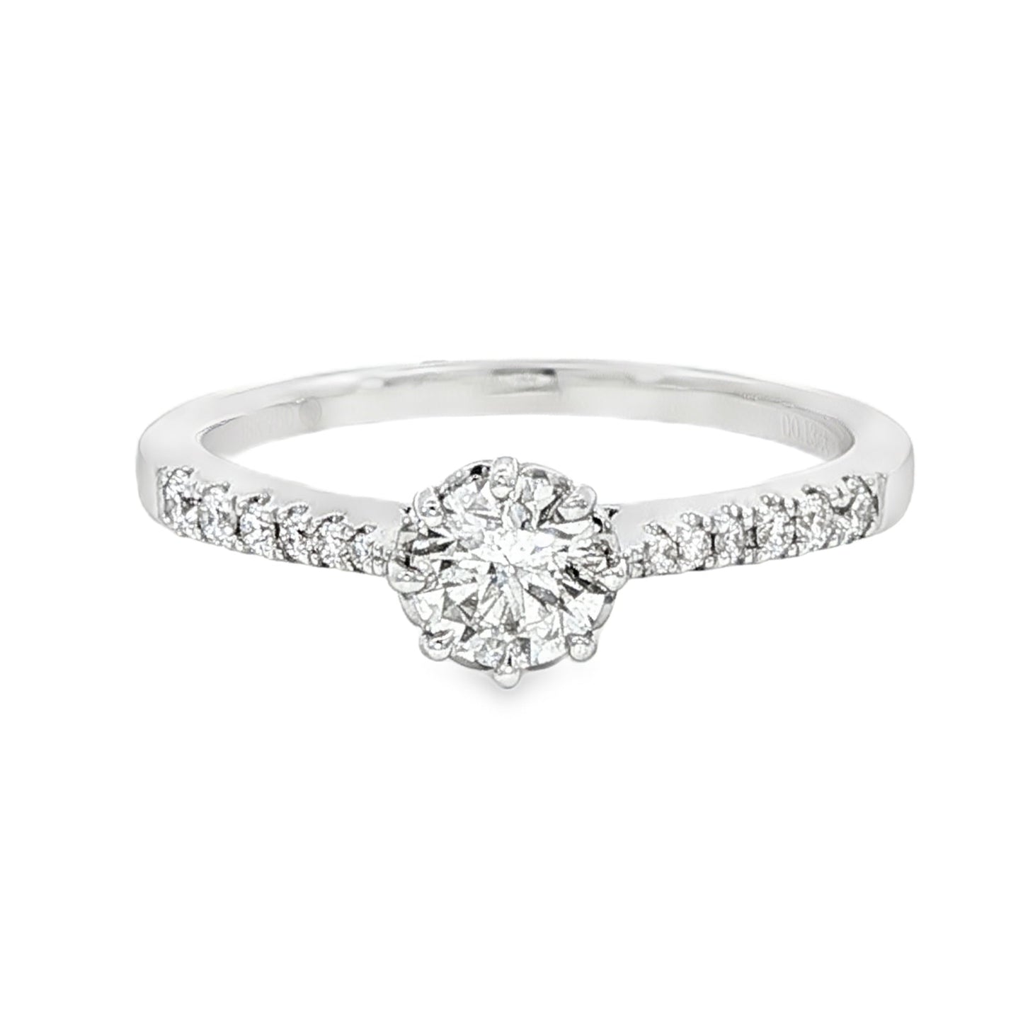 18K White gold ring featuring a round brilliant diamond center stone and accented with diamonds down the shank. Item J34776 - ABC Jewelry Co.