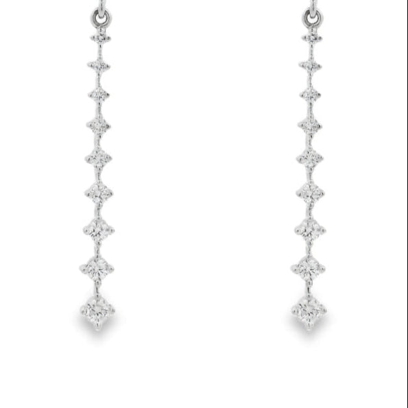 18K White gold dangle earrings with a vertical cascade of round brilliant diamonds. Item J36006 - ABC Jewelry Co