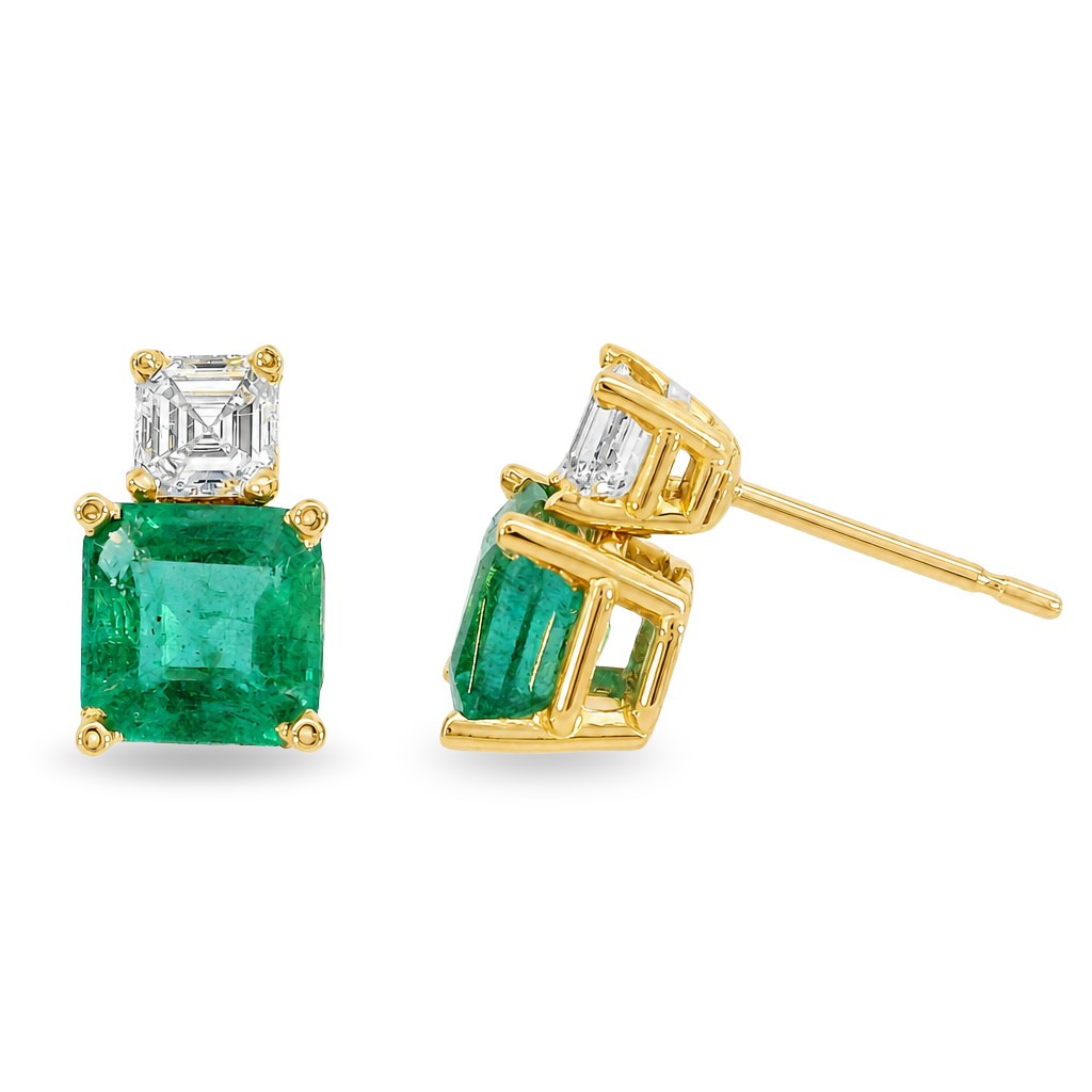 A pair of gold stud earrings featuring a large square-cut emerald gemstone and a smaller square-cut diamond above it, set in yellow gold prong settings on a white background.