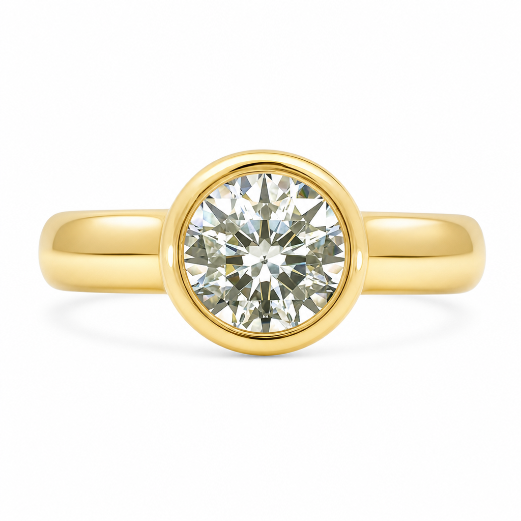 A yellow gold solitaire ring featuring a yellow toned round brilliant-cut diamond in a bezel setting, shown against a clean white background.