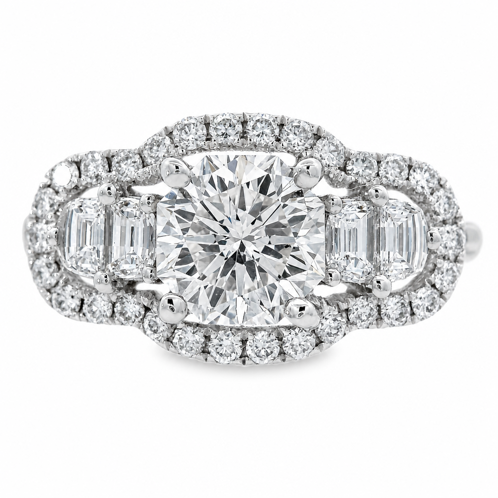 A white gold diamond ring with a octagonal center stone and half moon side stones, surrounded by a halo of small diamonds on a white background.