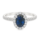 White gold ring with oval blue sapphire surrounded with a halo of diamonds on a diamond band. Shown on a clean white background.