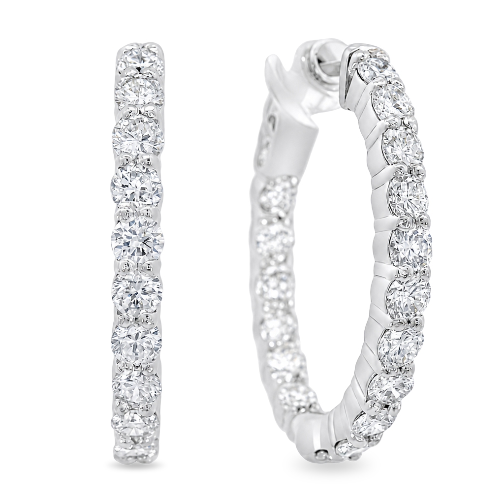 A pair of white gold hoop earrings set with round-cut clear gemstones, shown from two angles on a plain white background.