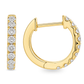 A pair of gold huggie hoop earrings set with round-cut clear gemstones, shown from the front and side on a plain white background.