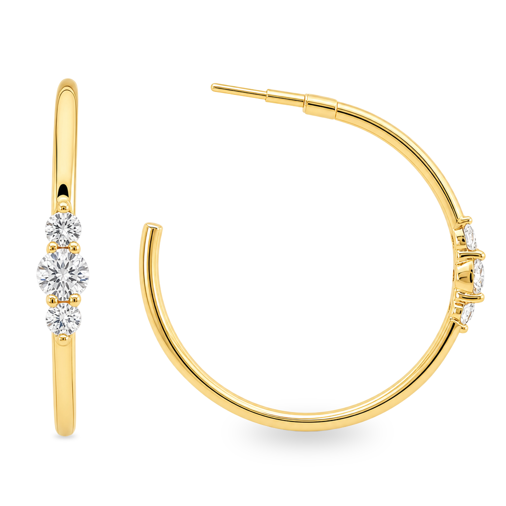 A pair of gold hoop earrings with three round-cut clear stones on each earring, shown on a clean white background.