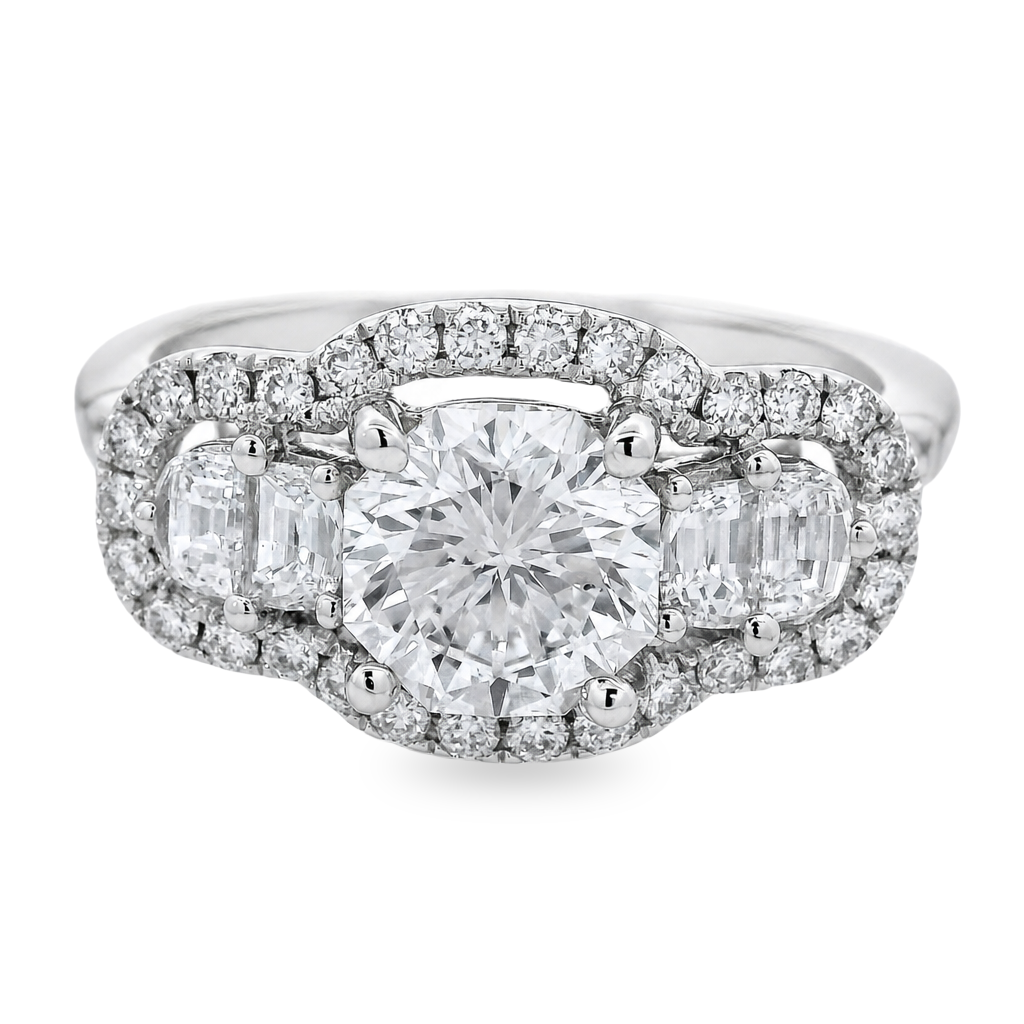 A white gold diamond ring with a octagonal center stone and half moon side stones, surrounded by a halo of small diamonds on a white background.