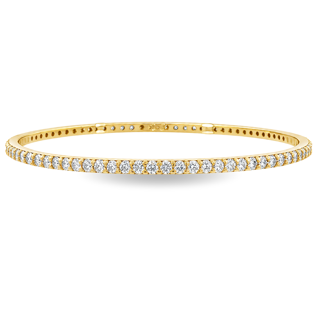 Yellow gold bangle set with a continuous row of round brilliant diamonds. Set on a clean white background. 