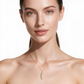 Yellow gold long bar pendant pave set with round brilliant diamonds. Shown on a female model set on a clean white background.