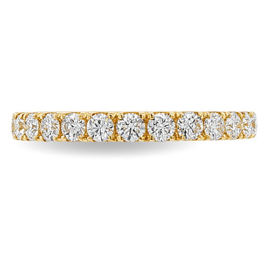A yellow gold band featuring a continuous row of round-cut diamonds set in a prong setting, shown on a clean white background.