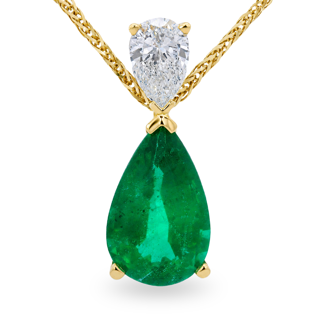 A yellow gold pendant necklace featuring a large teardrop-shaped emerald and a smaller pear shape diamond at the top, suspended from a gold chain on a white background.