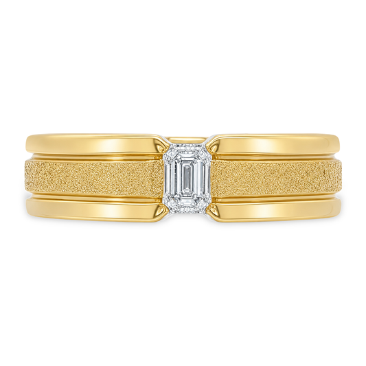 A yellow gold ring with a textured center band, a smooth outer band, and a rectangular emerald-cut diamond in the middle, shown on a plain white background.