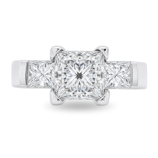 A three-stone diamond ring featuring a large princess-cut center diamond flanked by two smaller princess-cut side diamonds, set in a polished white gold band on a clean white background.