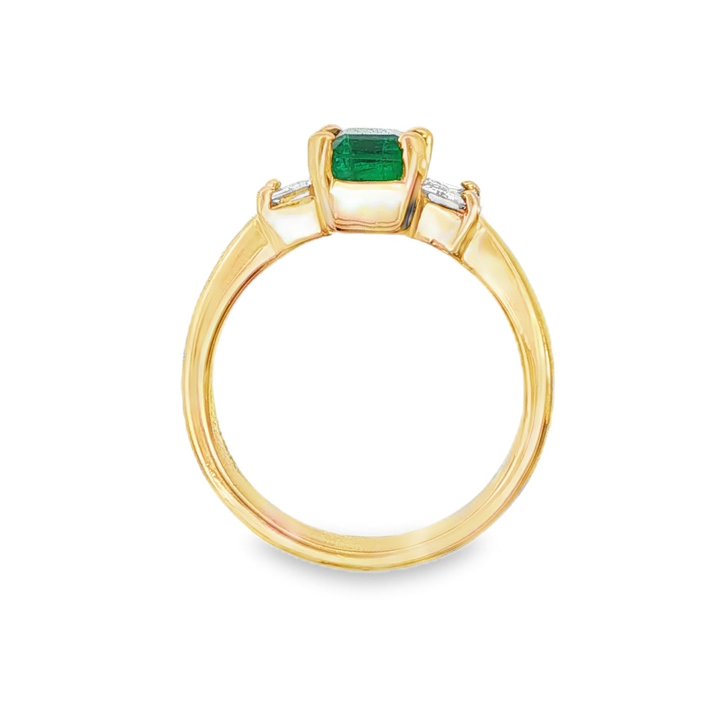 18K Yellow gold ring set with an emerald cut emerald and two baguette diamonds. Item J31312 - ABC Jewelry Co.