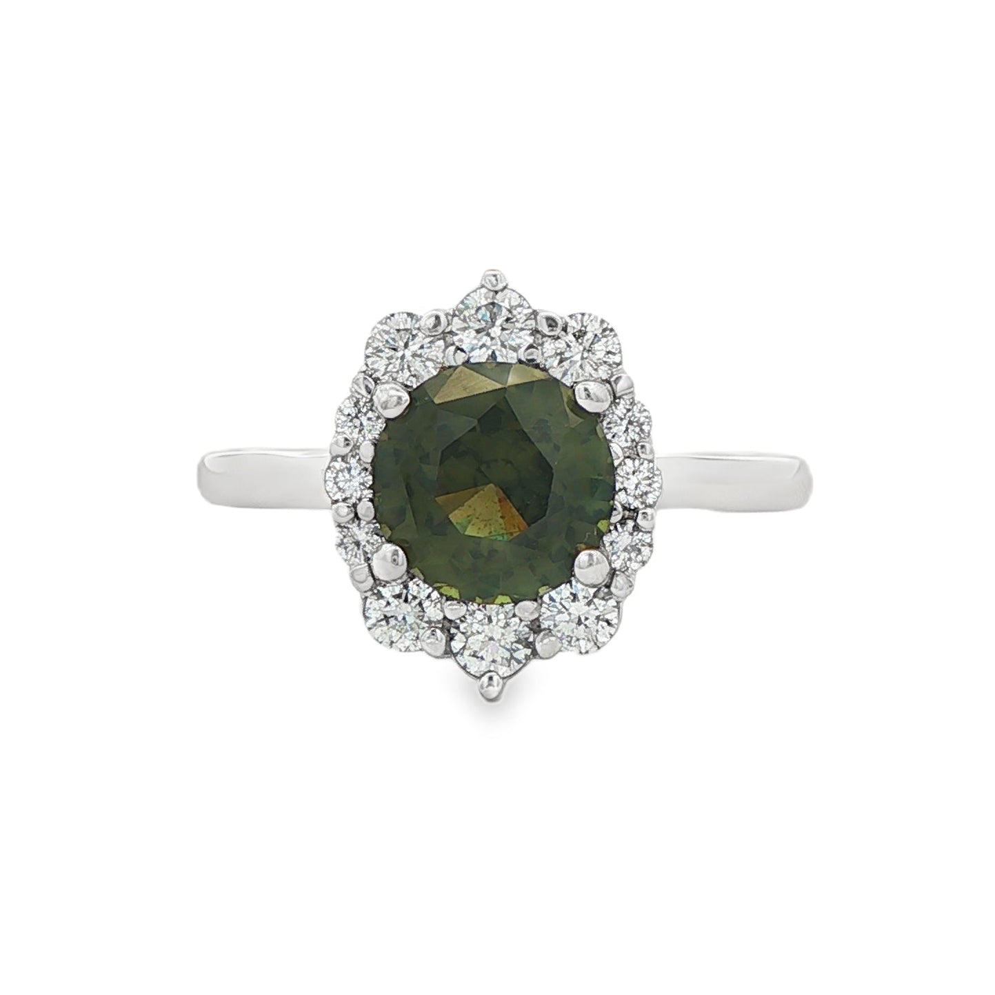 14K White gold ring set with a round green sapphire surrounded by a halo of round diamonds. Item, J31925 - ABC Jewelry Co.