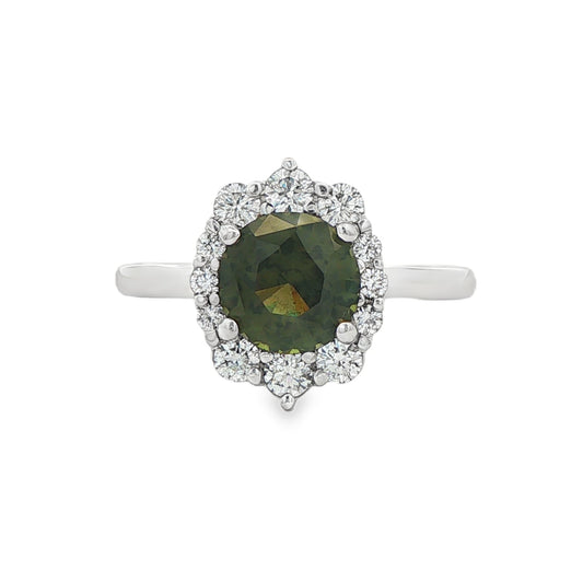 14K White gold ring set with a round green sapphire surrounded by a halo of round diamonds. Item, J31925 - ABC Jewelry Co.