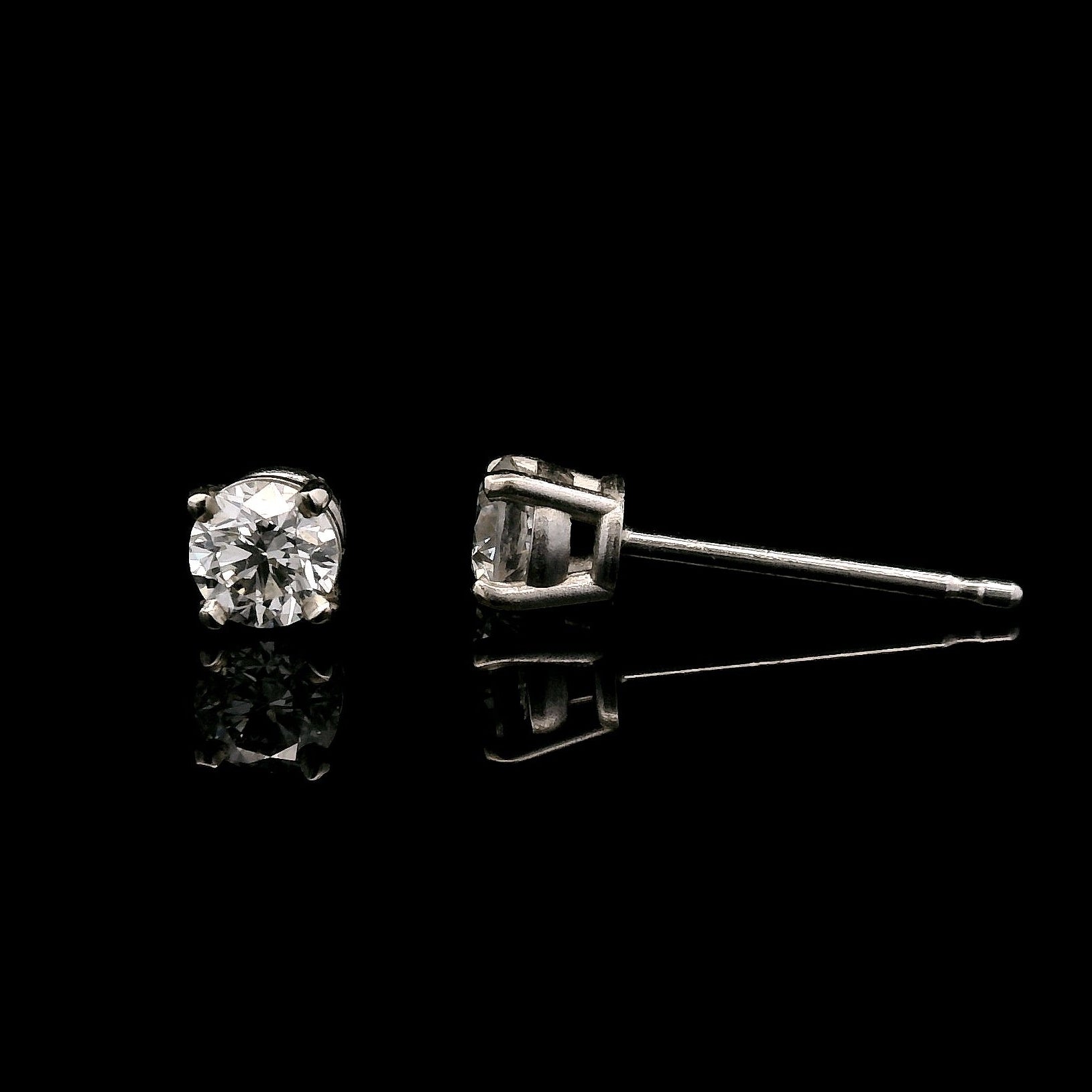 14K White gold stud earrings set with round brilliant diamonds. Item J33030 - ABC Jewelry Co.