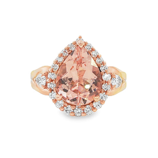 14K Rose gold ring set with a pear shape morganite surrounded with a diamond halo. Item J33283 - ABC Jewelry Co. 