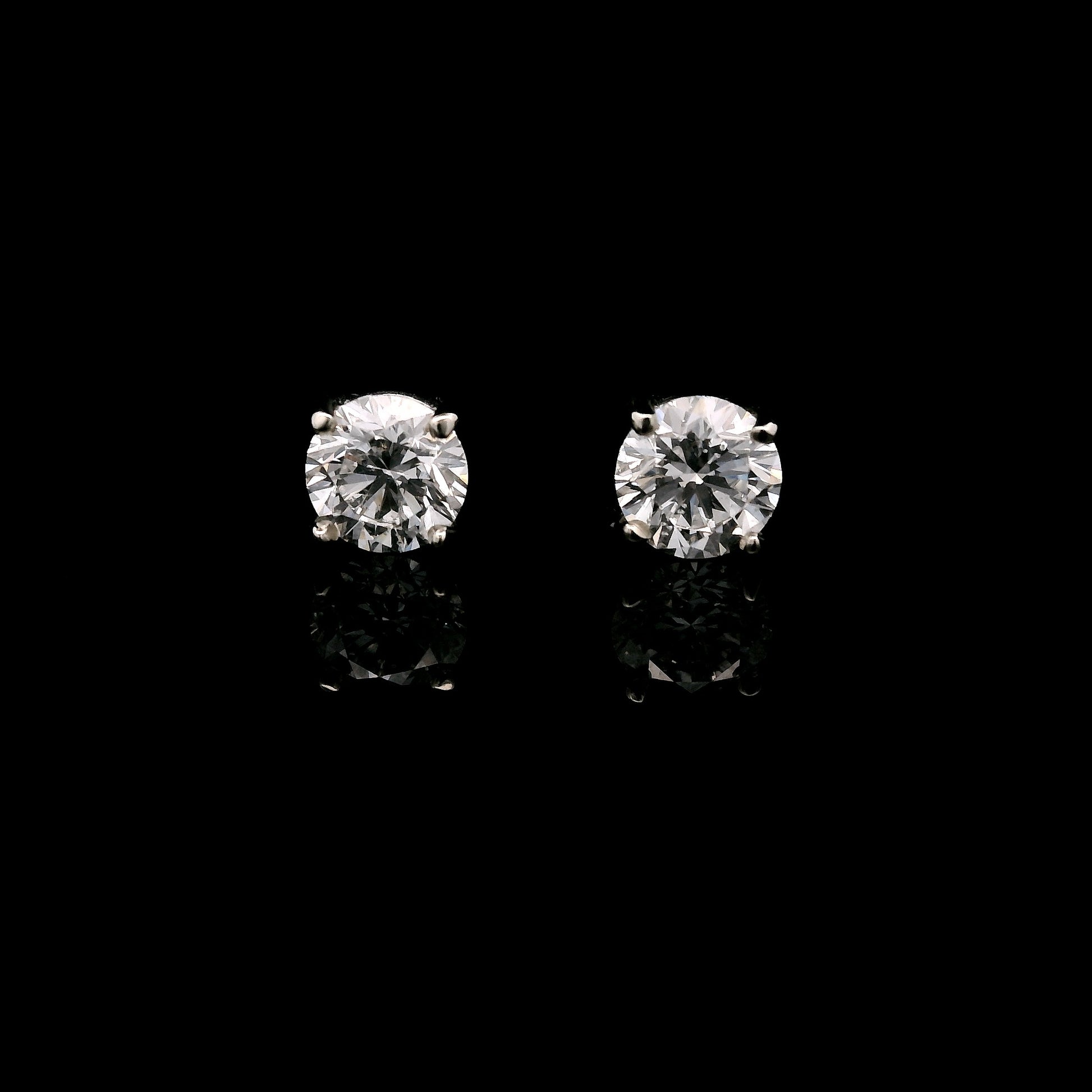 14K White gold stud earrings set with round brilliant diamonds. Item J34122 - ABC Jewelry Co.