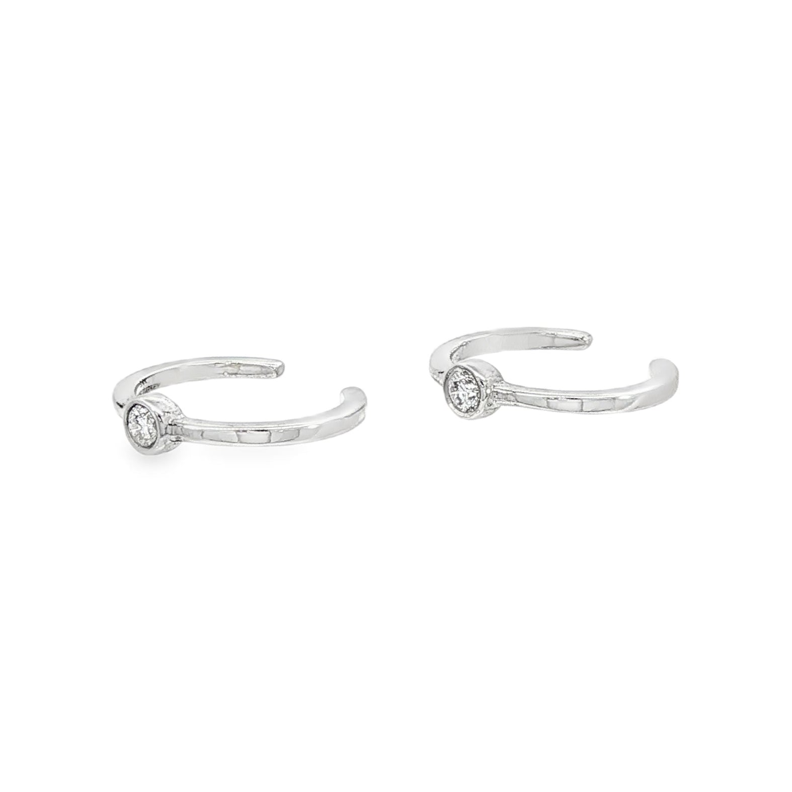 14K White gold ear cuffs, each with 1 bezel set round brilliant diamond. Item J34614 - ABC Jewelry Co.