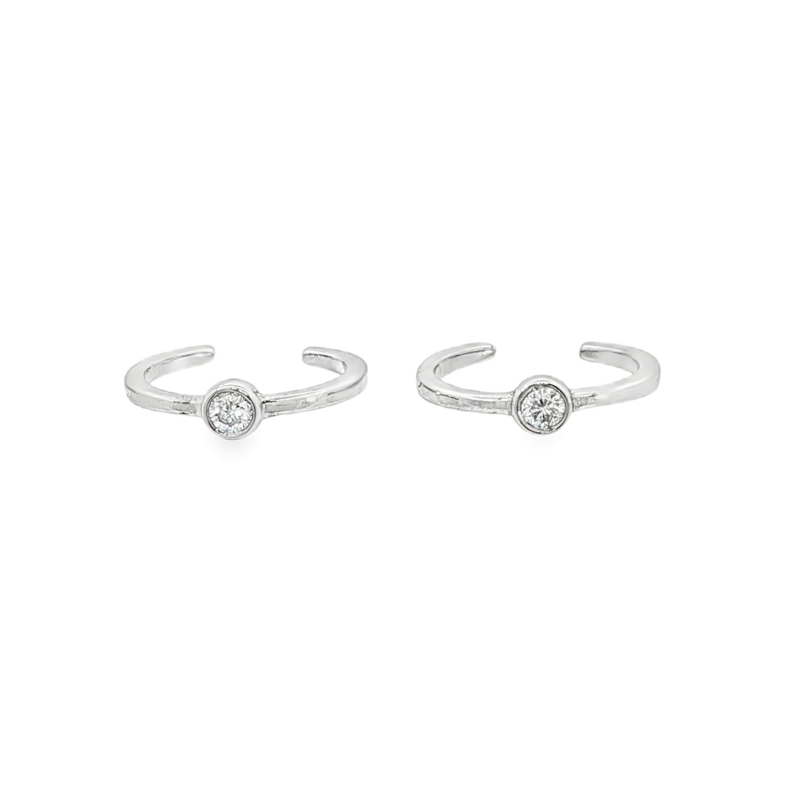14K White gold ear cuffs, each with 1 bezel set round brilliant diamond. Item J34614 - ABC Jewelry Co.