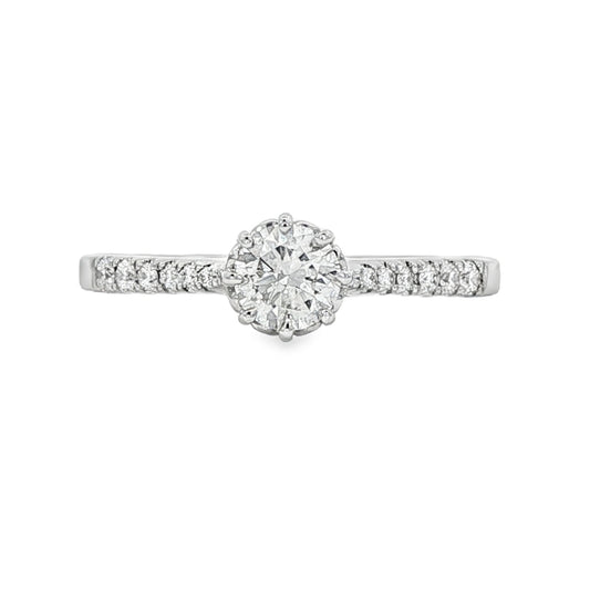 18K White gold ring featuring a round brilliant diamond center stone and accented with diamonds down the shank. Item J34776 - ABC Jewelry Co.