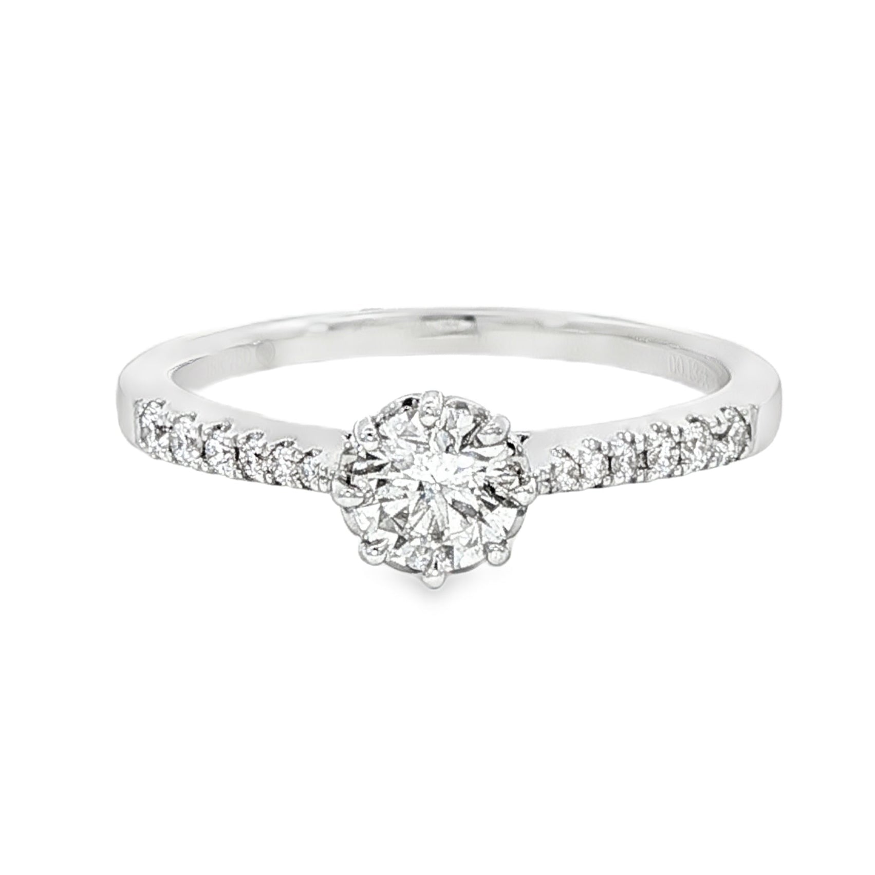 18K White gold ring featuring a round brilliant diamond center stone and accented with diamonds down the shank. Item J34776 - ABC Jewelry Co.