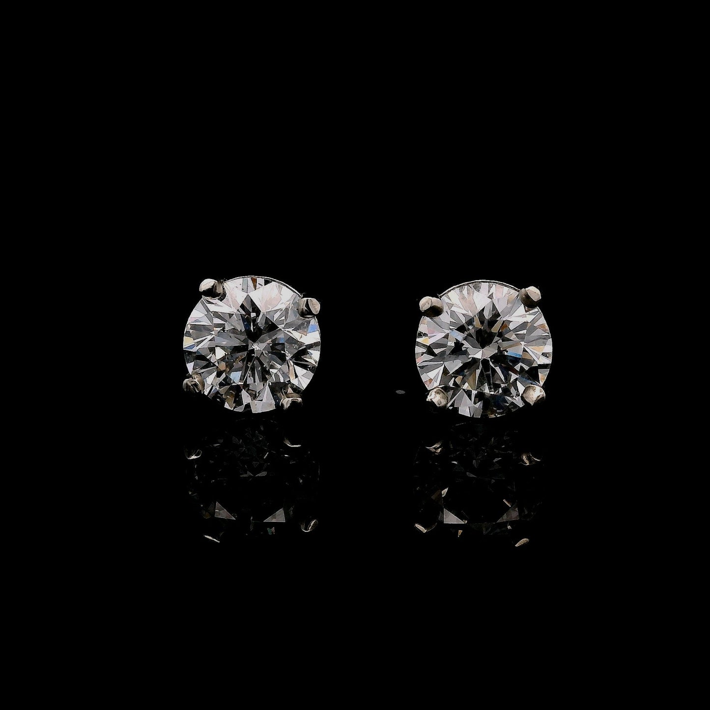 14K White gold stud earrings set with round brilliant diamonds. Item J34789 - ABC Jewelry Co.