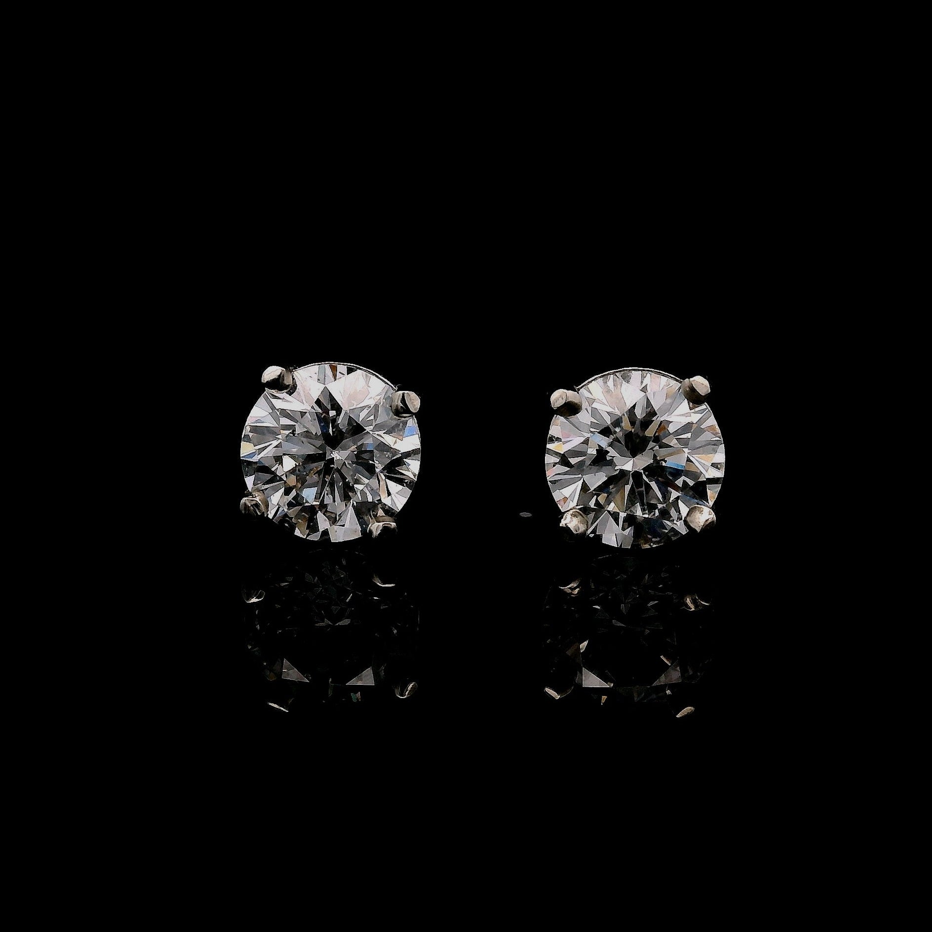 14K White gold stud earrings set with round brilliant diamonds. Item J34789 - ABC Jewelry Co.