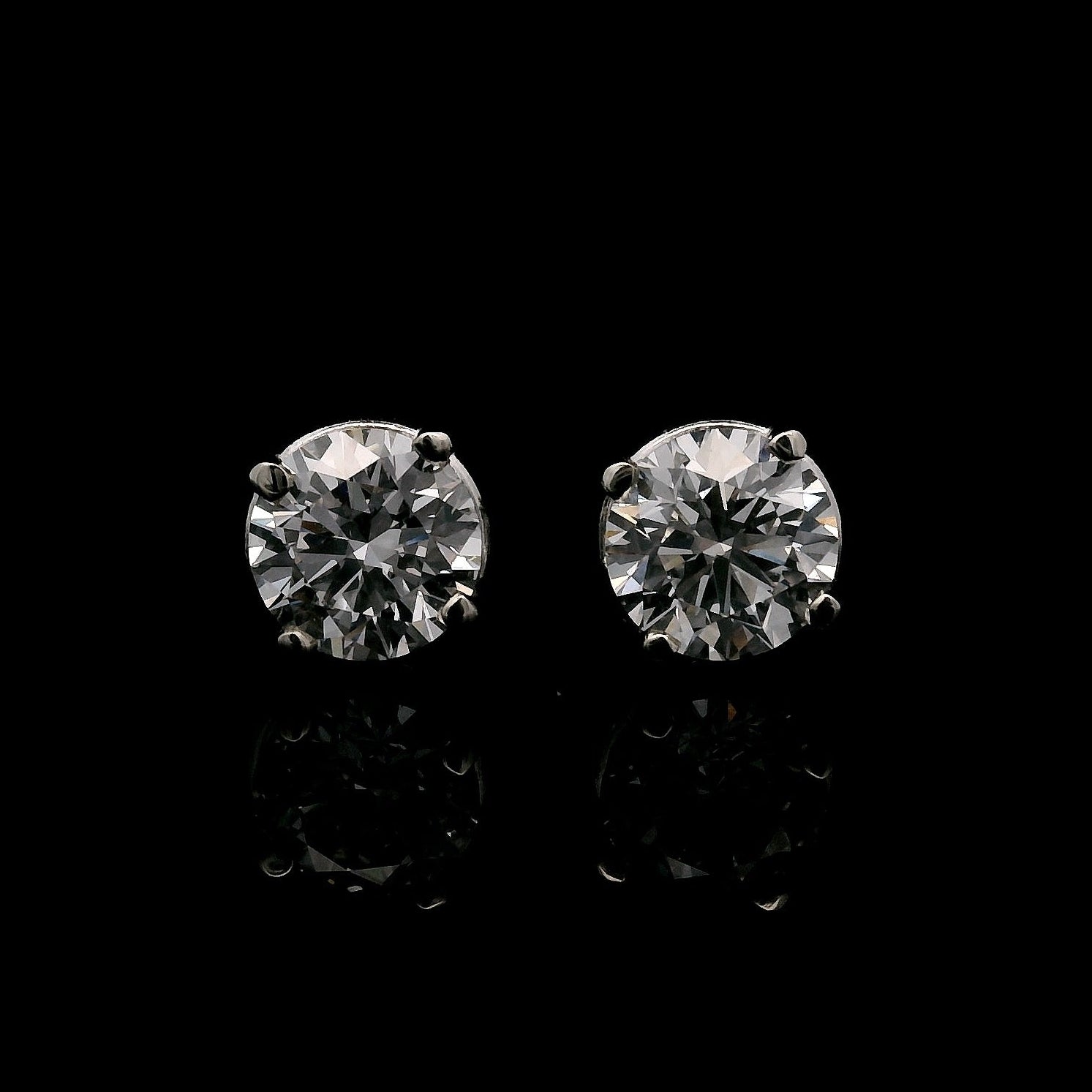 14K White gold stud earrings set with 2 round brilliant diamonds. Item J34919 - ABC Jewelry Co. 