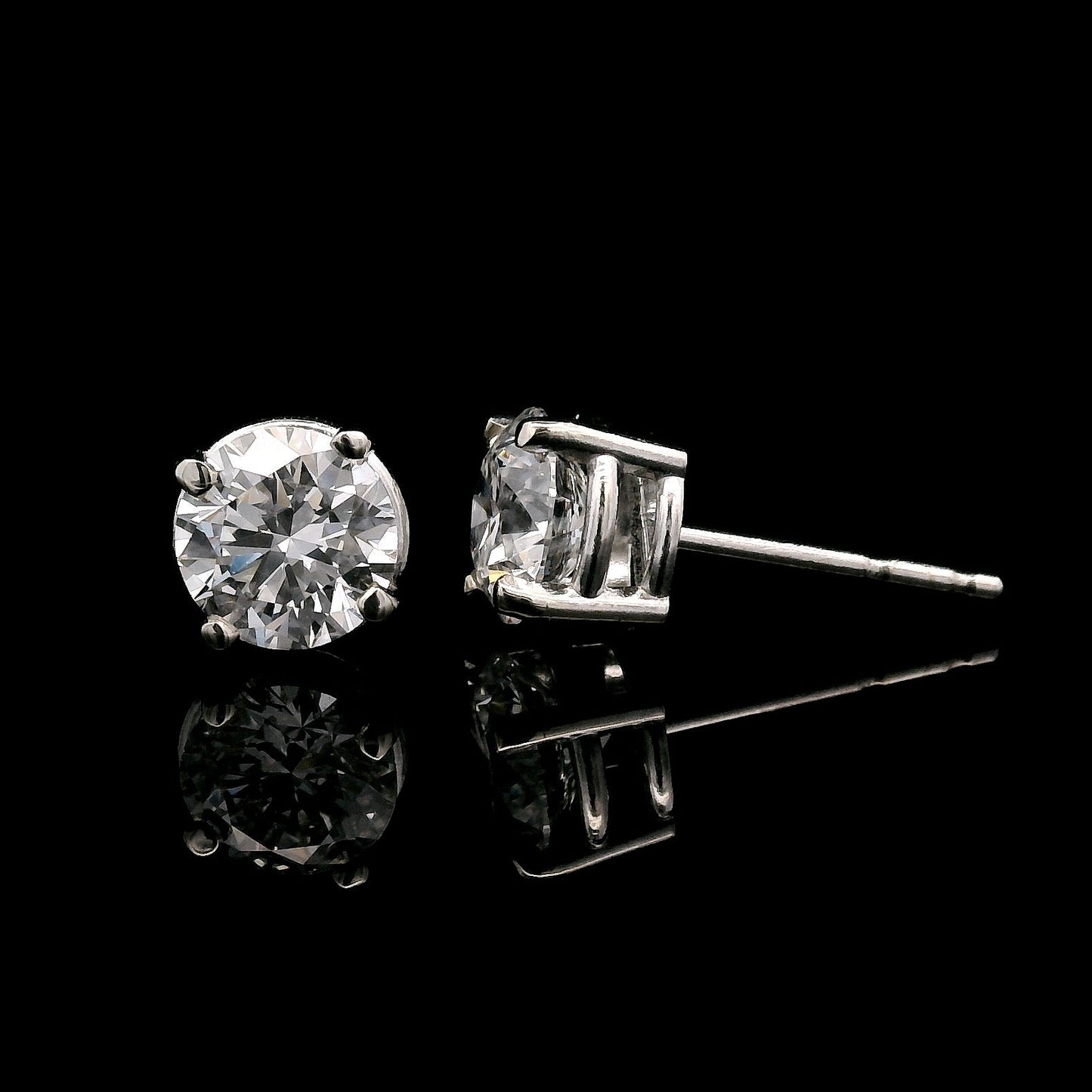 14K White gold stud earrings set with 2 round brilliant diamonds. Item J34919 - ABC Jewelry Co. 
