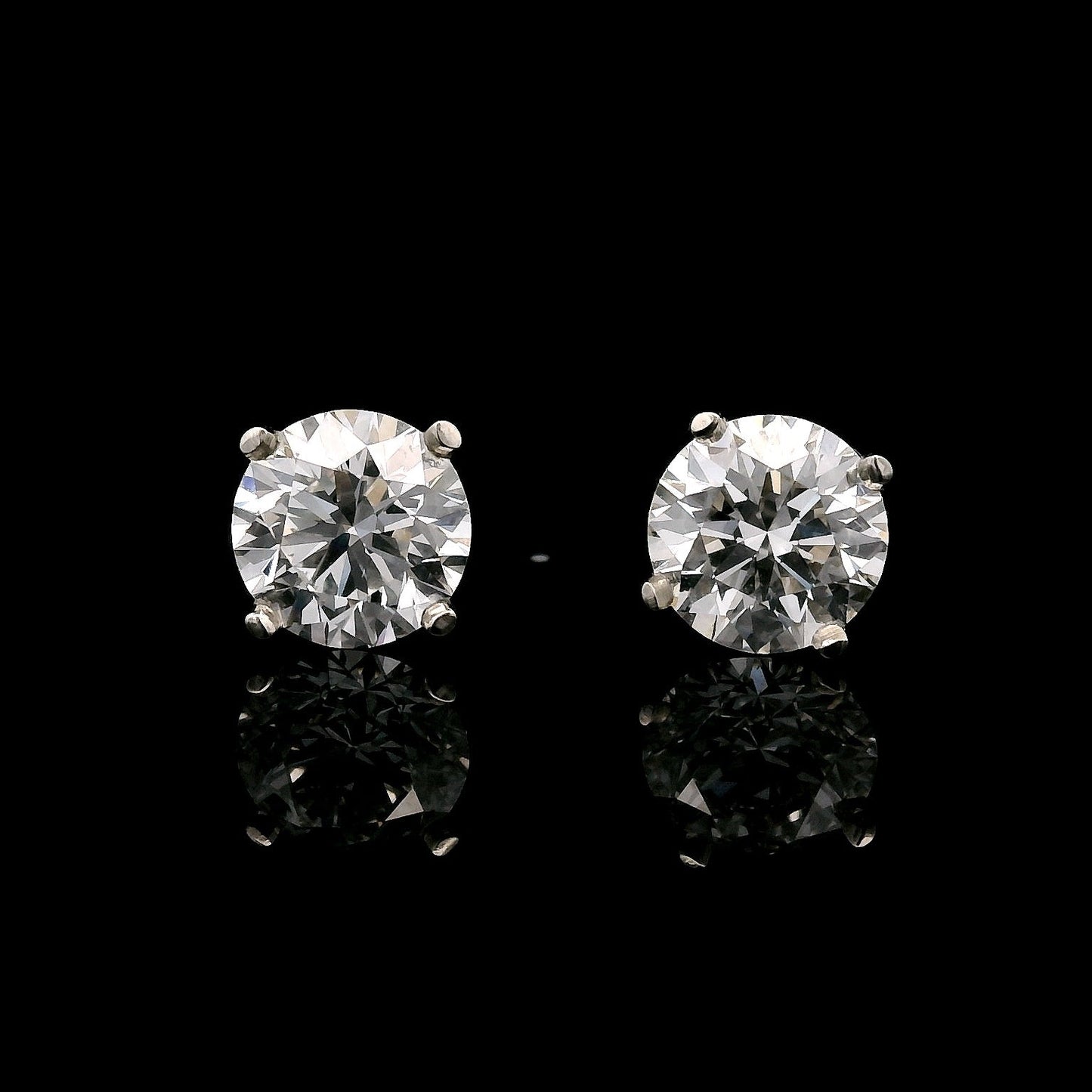 14K White gold stud earrings set with 2 round brilliant diamonds. Item J35626 - ABC Jewelry Co. 