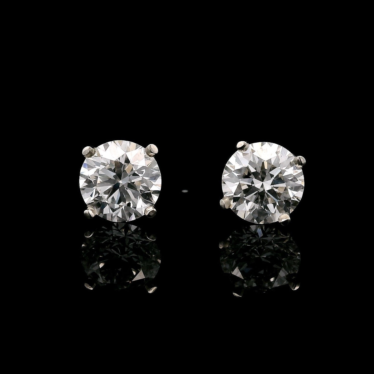 14K White gold stud earrings set with 2 round brilliant diamonds. Item J35626 - ABC Jewelry Co. 