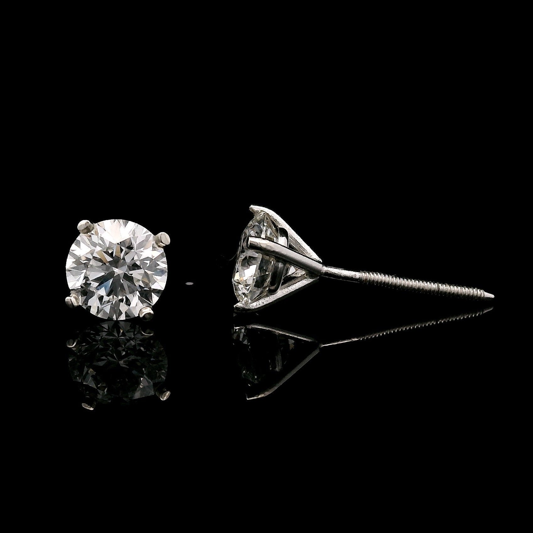 14K White gold stud earrings set with 2 round brilliant diamonds. Item J34919 - ABC Jewelry Co. 