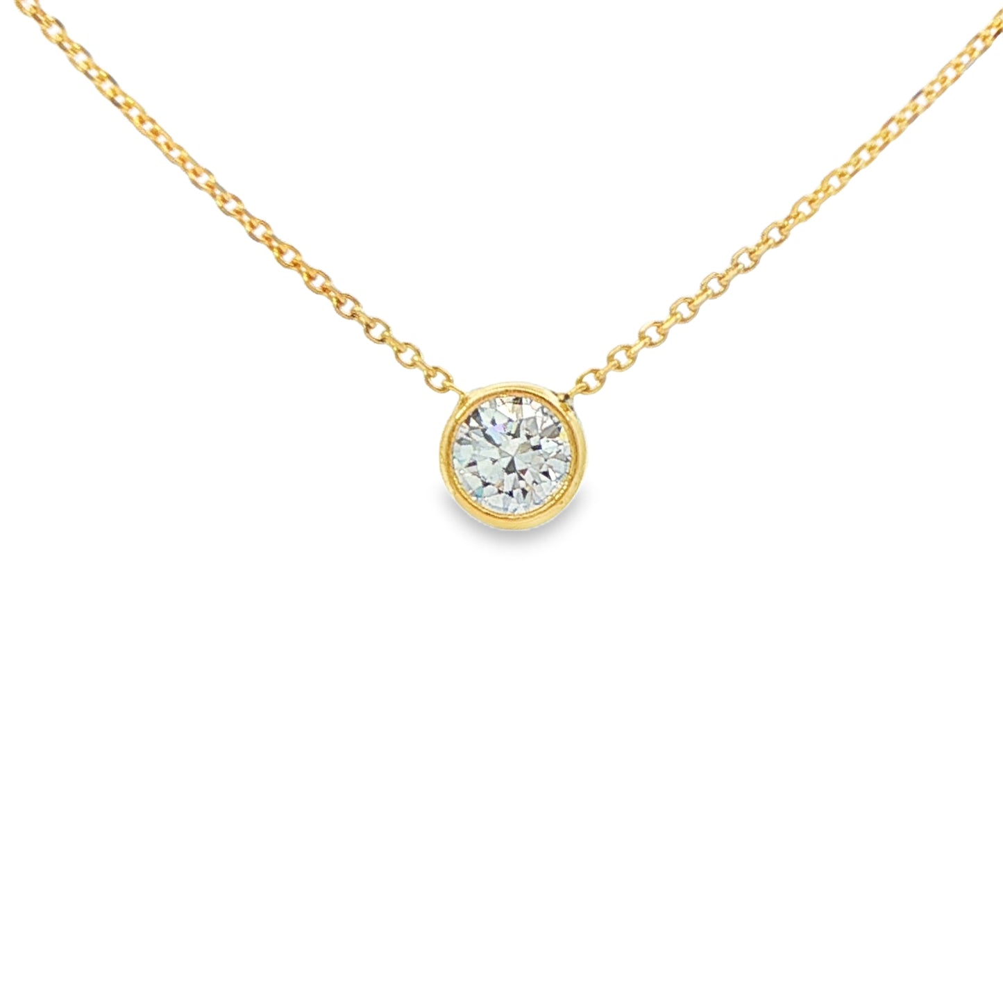 14K Yellow gold solitaire necklace with a bezel set round brilliant diamond. Item J36073 - ABC Jewelry Co. 