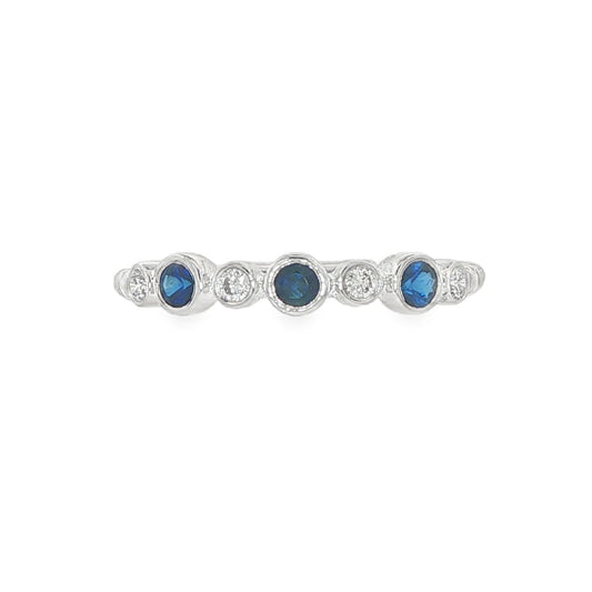 18K White gold band bezel set with blue sapphires and round brilliant diamonds. Item J36395 - ABC Jewelry Co. 