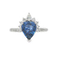 18K White gold ring set with a pear shape blue sapphire crowned with diamonds. Item J36871 - ABC Jewelry Co. 