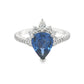 18K White gold ring set with a pear shape blue sapphire crowned with diamonds. Item J36871 - ABC Jewelry Co. 
