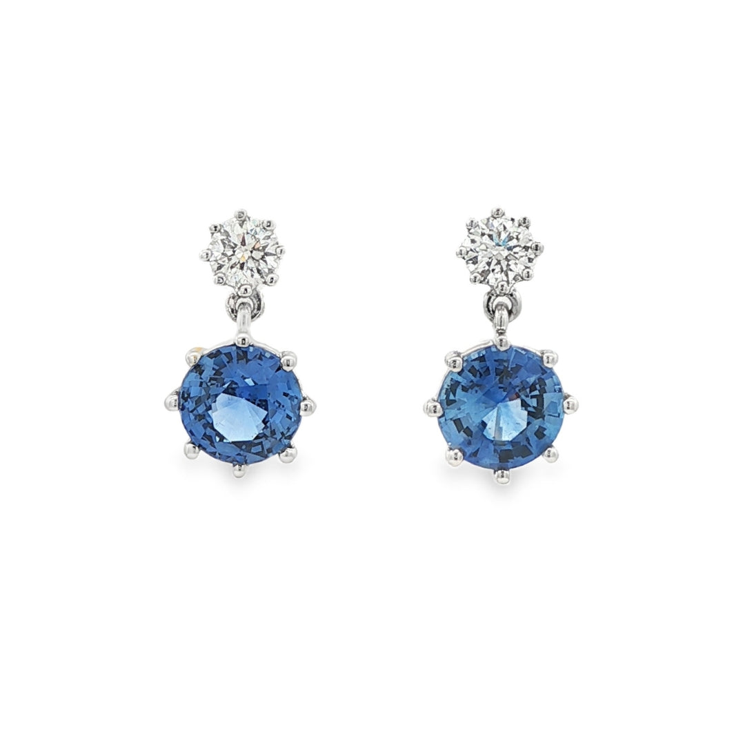 14K White gold drop earrings set with blue sapphires and round brilliant diamonds. Item J37495 - ABC Jewelry Co.