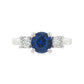 18K White gold ring set with one round blue sapphire and two round brilliant diamonds. Item J37692 - ABC Jewelry Co. 