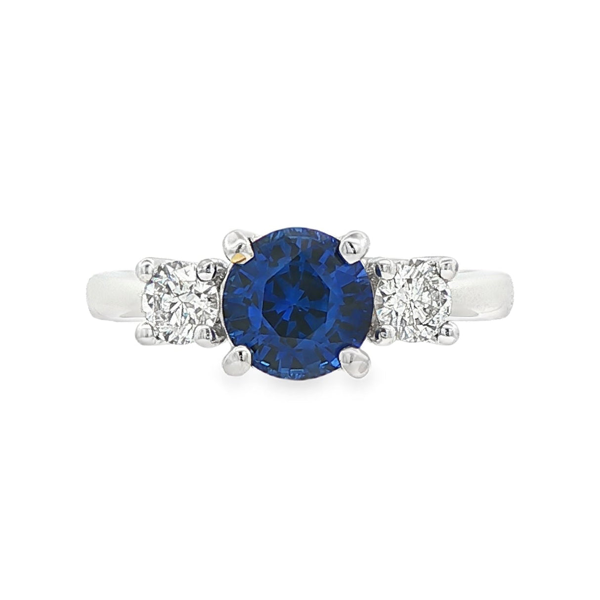 18K White gold ring set with one round blue sapphire and two round brilliant diamonds. Item J37692 - ABC Jewelry Co. 