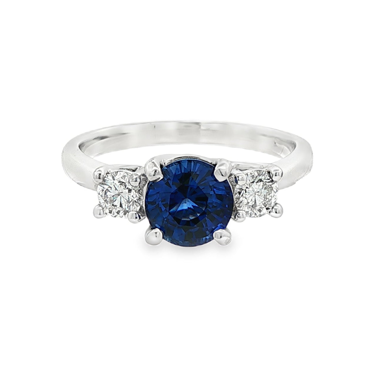 18K White gold ring set with one round blue sapphire and two round brilliant diamonds. Item J37692 - ABC Jewelry Co. 