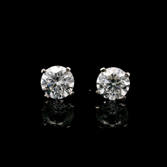 14K White gold stud earrings set with 2 natural mined diamonds. Item J37802 - ABC Jewelry Co