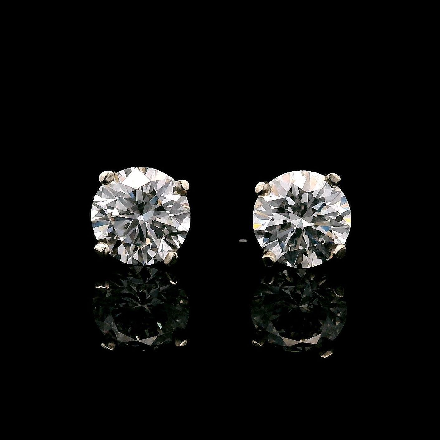 14K White gold stud earrings set with round brilliant diamonds. Item J37804 - ABC Jewelry Co.