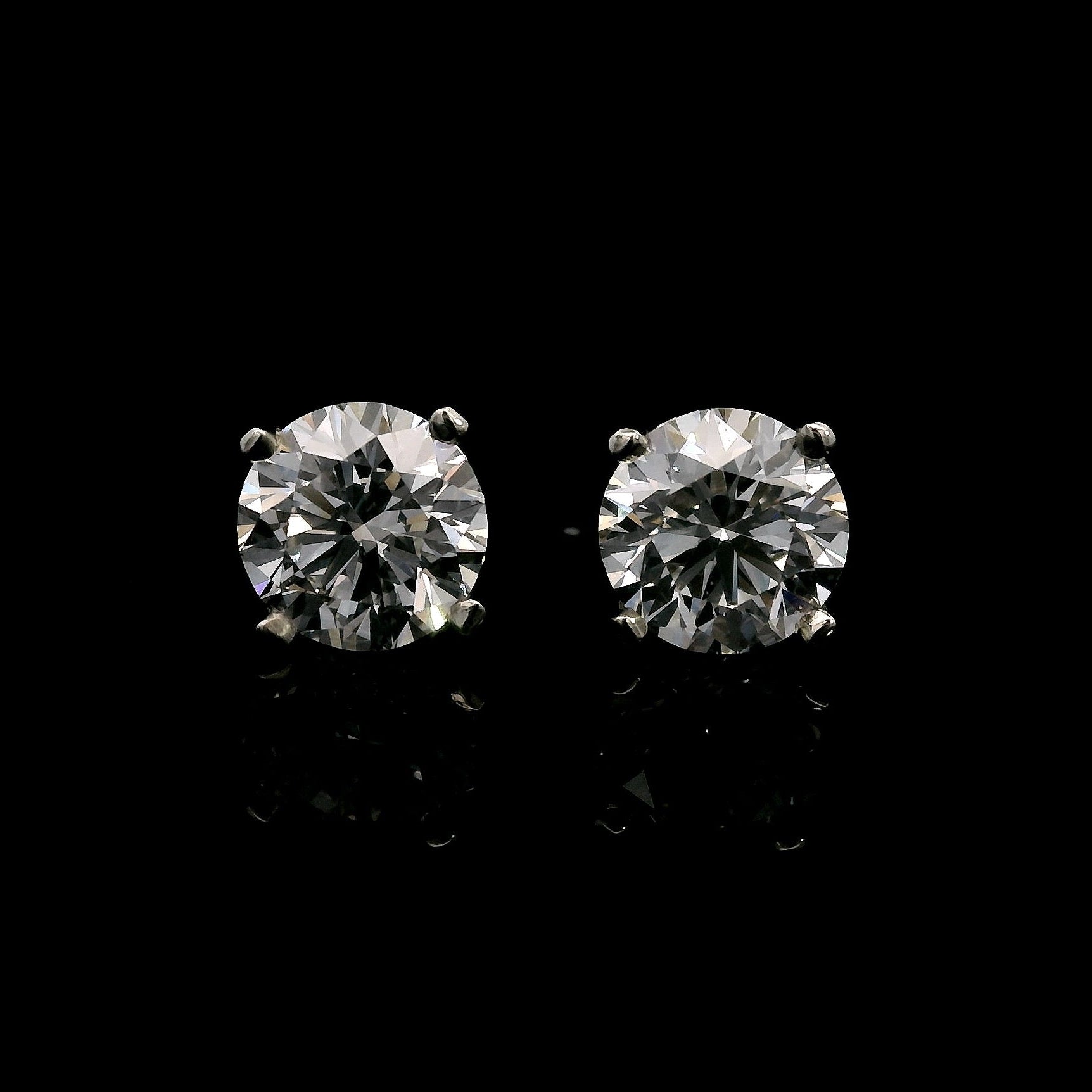 14K White gold stud earrings set with round brilliant diamonds. Item J37810 - ABC Jewelry Co.