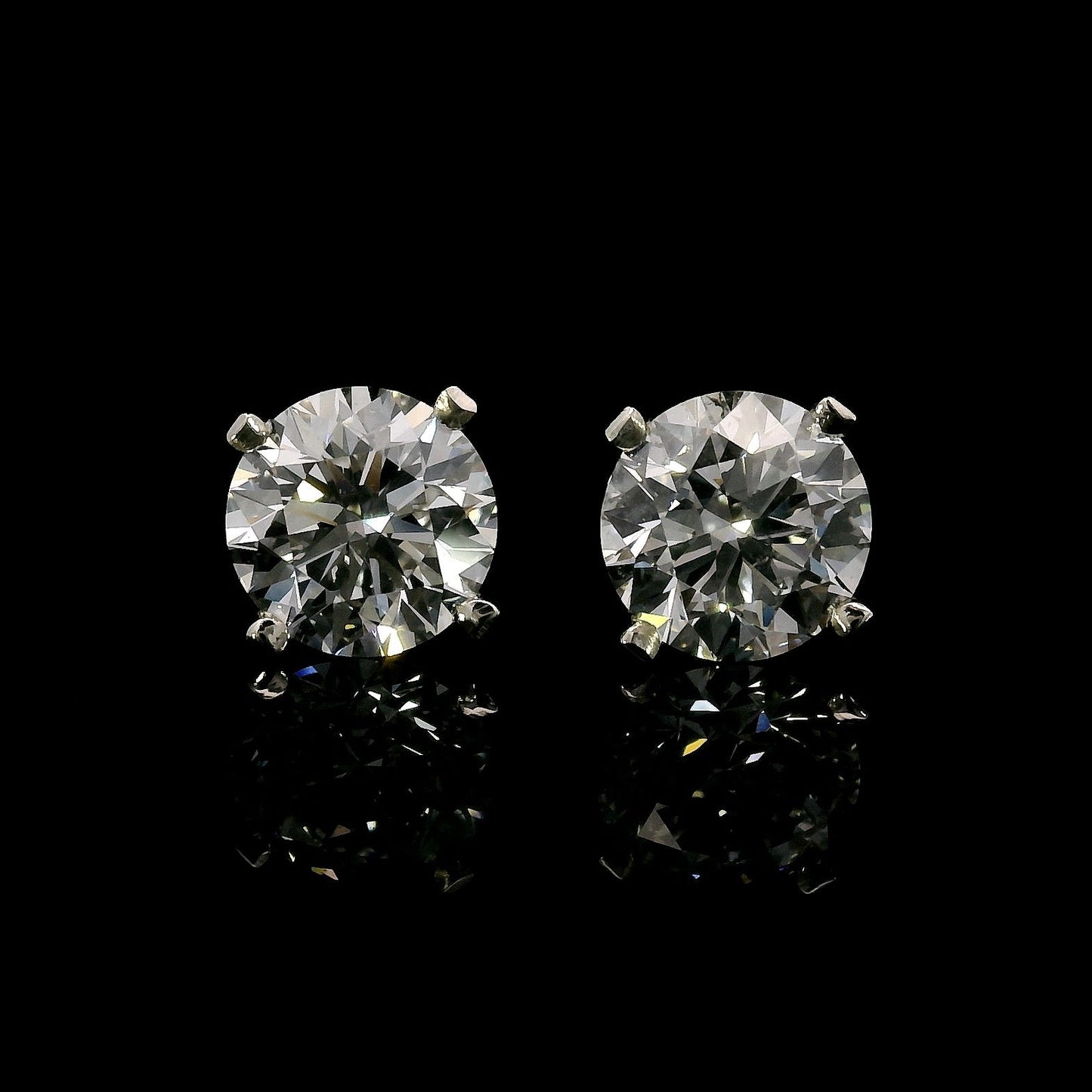 14K White gold stud earrings set with round brilliant diamonds. Item J37811 - ABC Jewelry Co.