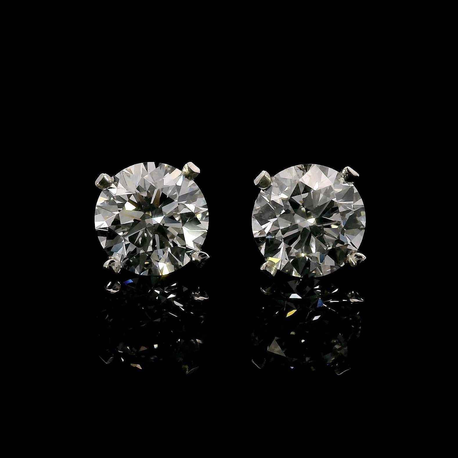 14K White gold stud earrings set with round brilliant diamonds. Item J37811 - ABC Jewelry Co.